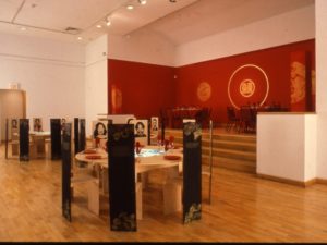 Photo of multiple tables set with photos at each seat.