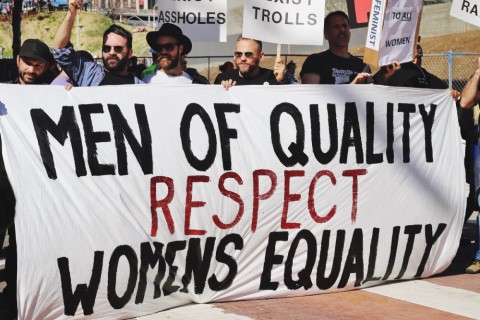 At 2017 Women’s March in Los Angeles, group of men holding a sign that says, “Men of quality respect women's equality.”