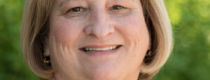 Close up photo of Judy Casteele, smiling.