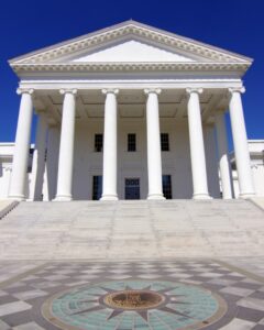 Head-on Image of the front of Virginia State Capitol with blue sky.